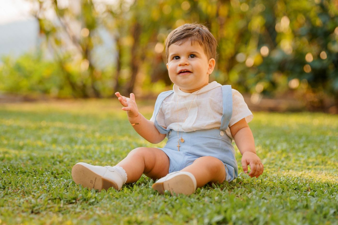 Baby sitting on the grass in the late afternoon