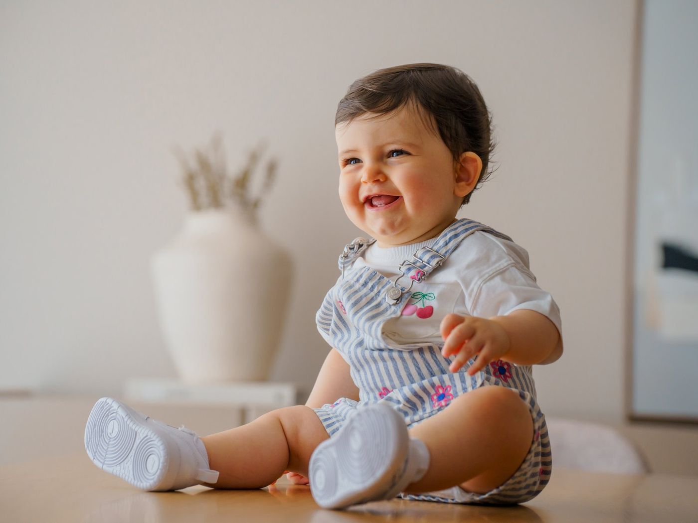 Baby laughing against a light background
