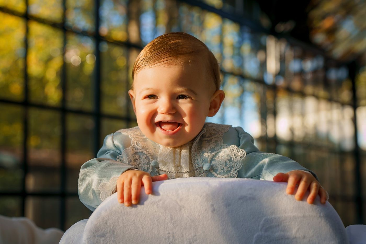 Baby laughing in a glasshouse