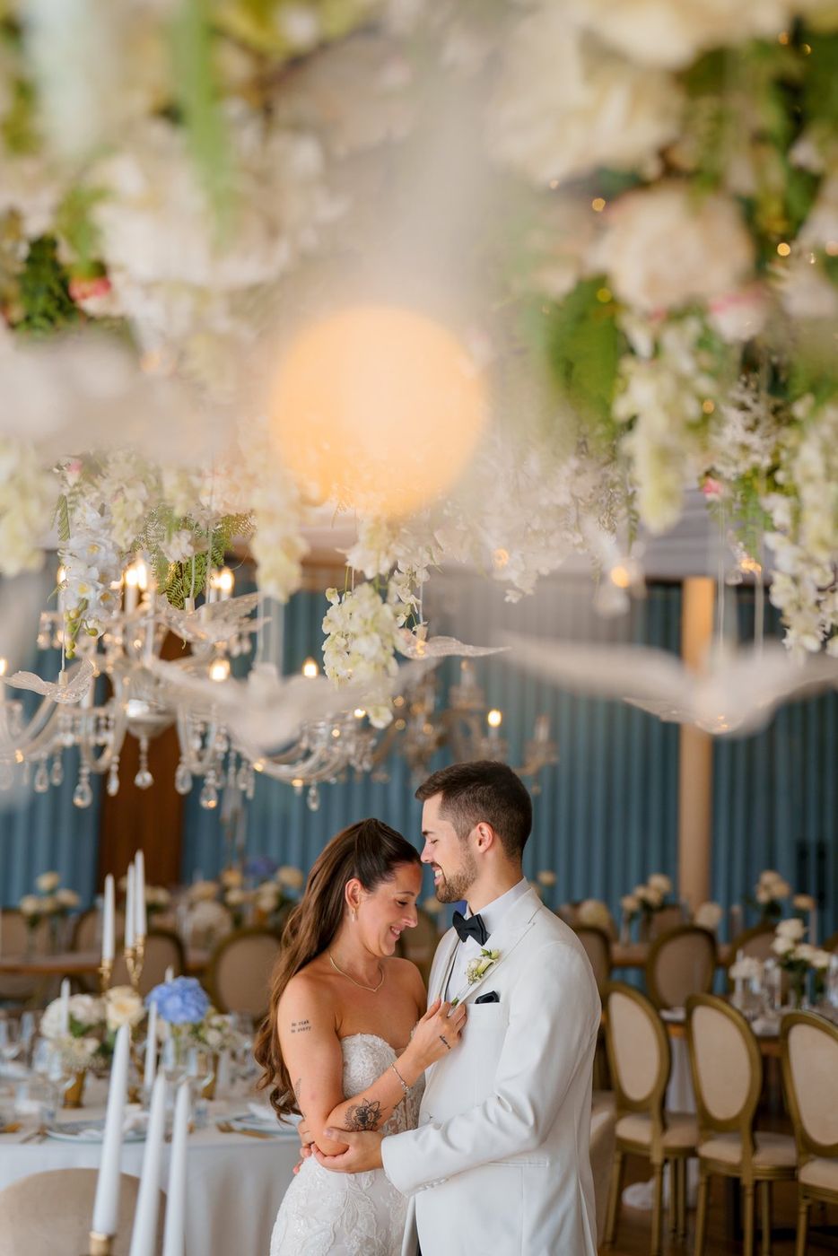 Bride and groom in a hall with lights and flowers