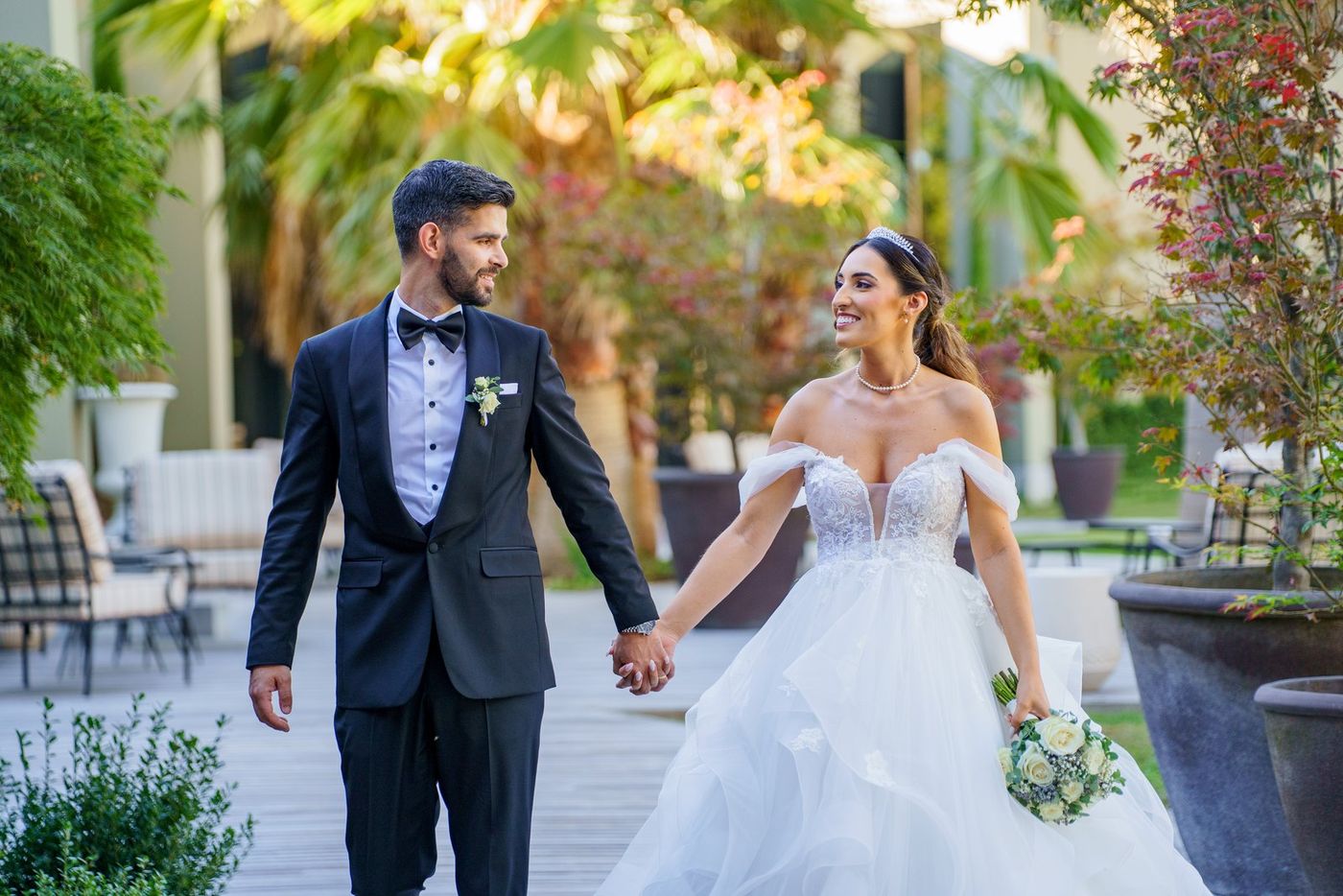 Bride and groom walking hand in hand, laughing