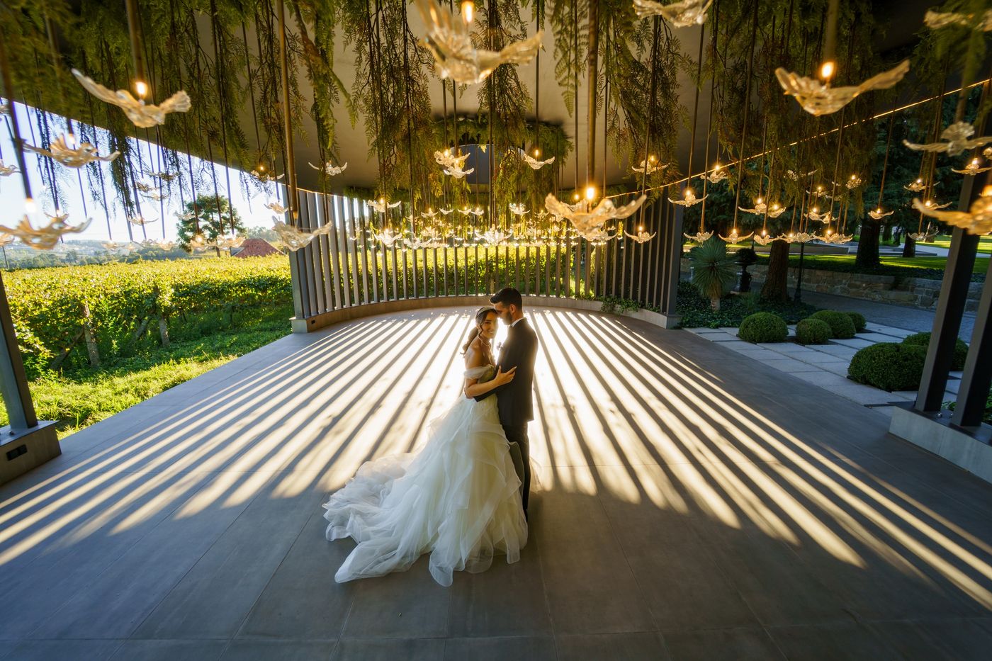 Bride and groom between stripes of light and shadow
