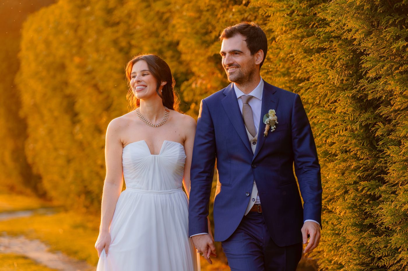 Bride and groom walking in the late afternoon