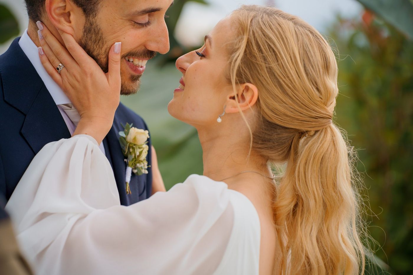 Bride with her hand on the groom's face