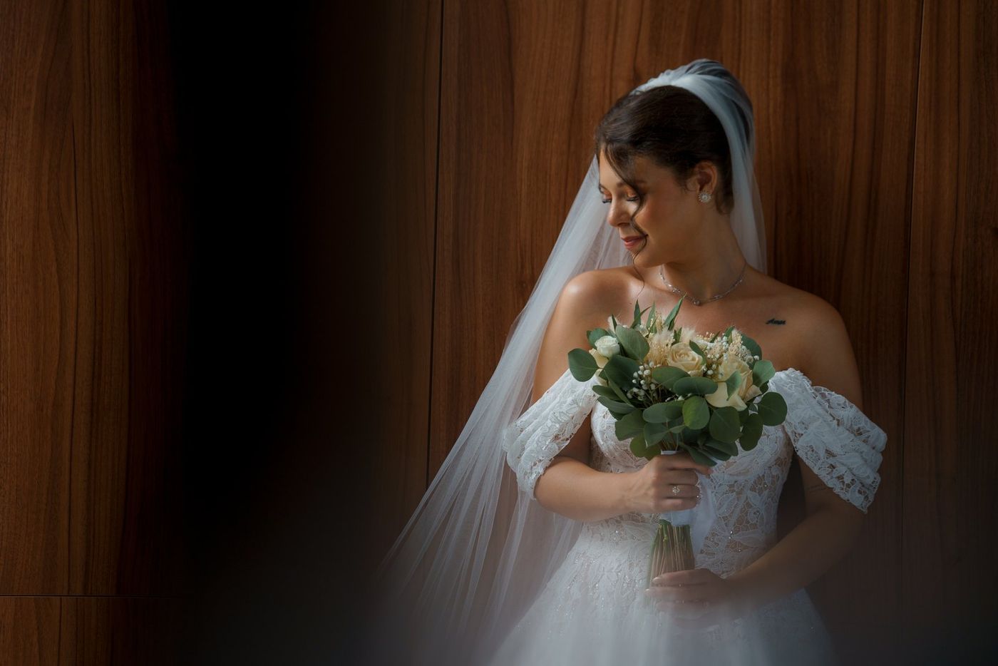 Bride with veil and bouquet in soft light