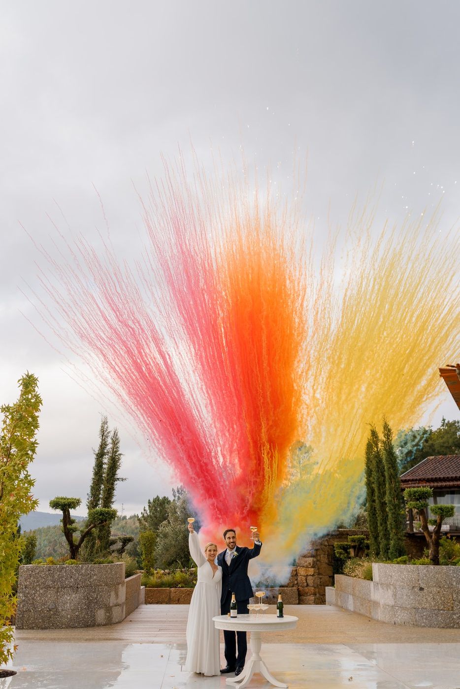 Bride and groom with giant coloured smoke