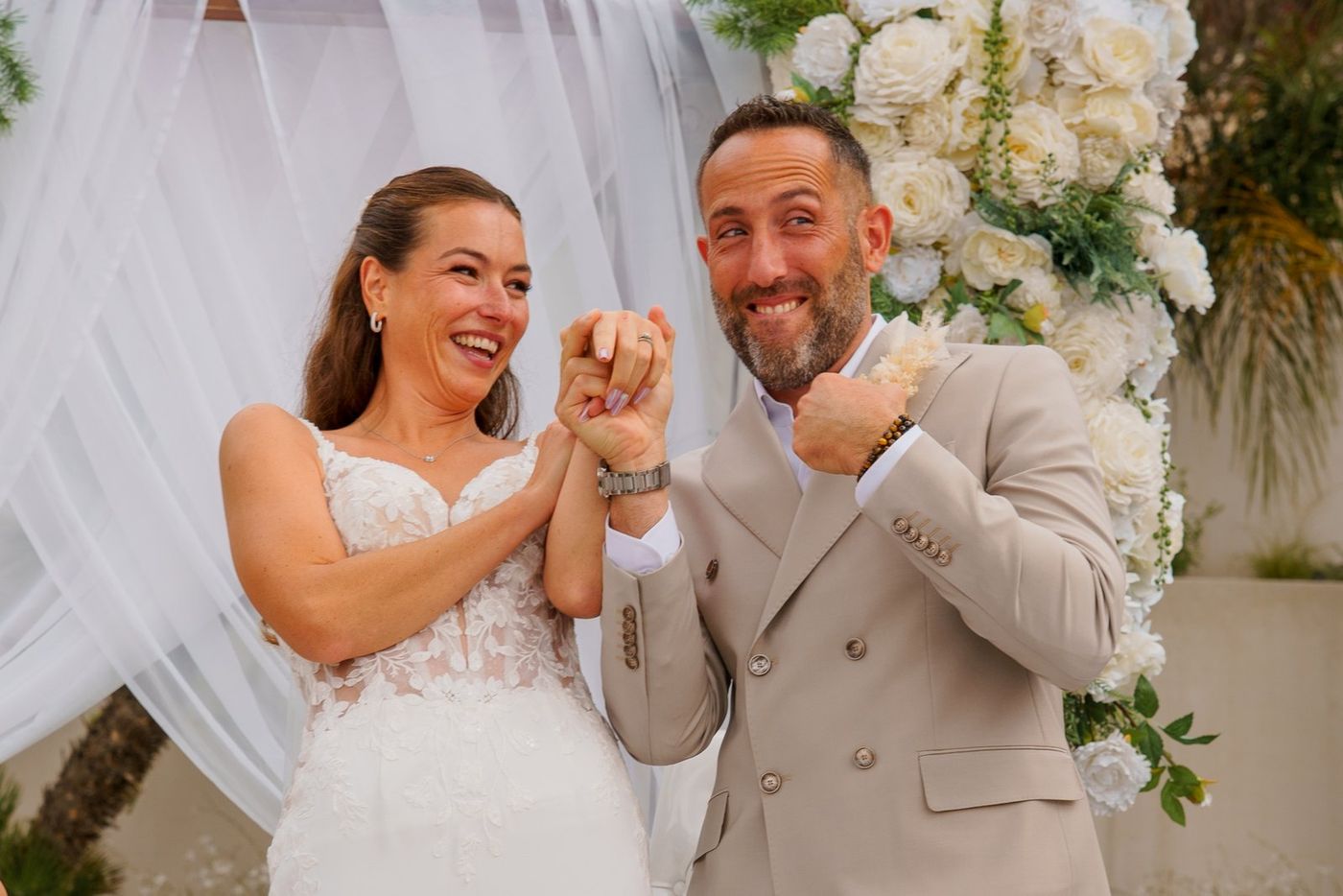 Bride and groom showing their rings