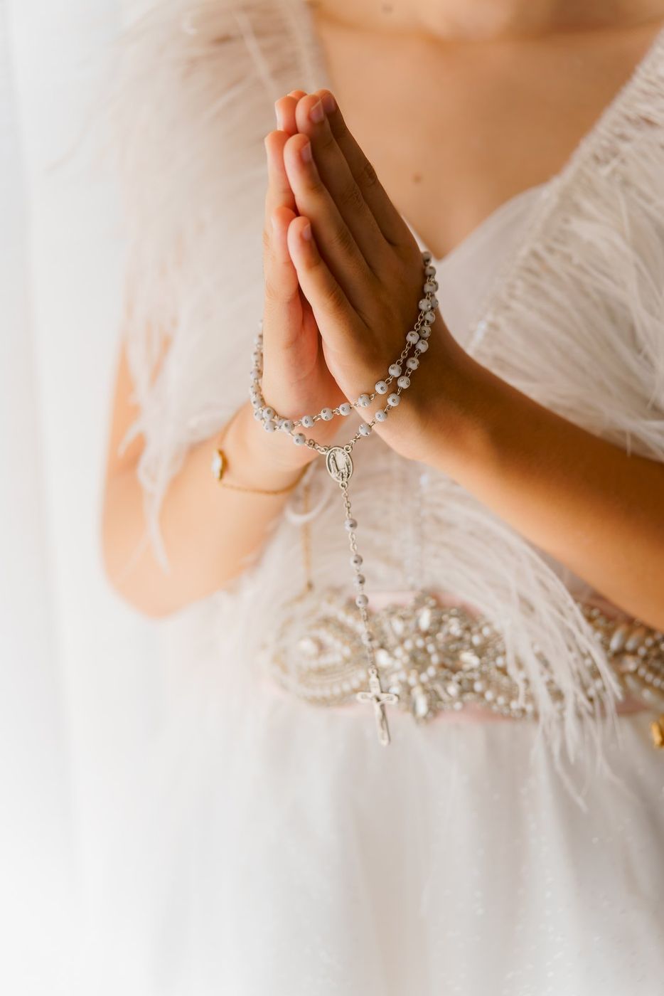 Hands with the rosary and the dress
