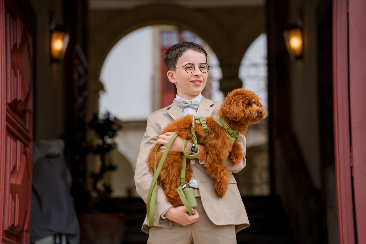 Communion boy with his dog under the arcades