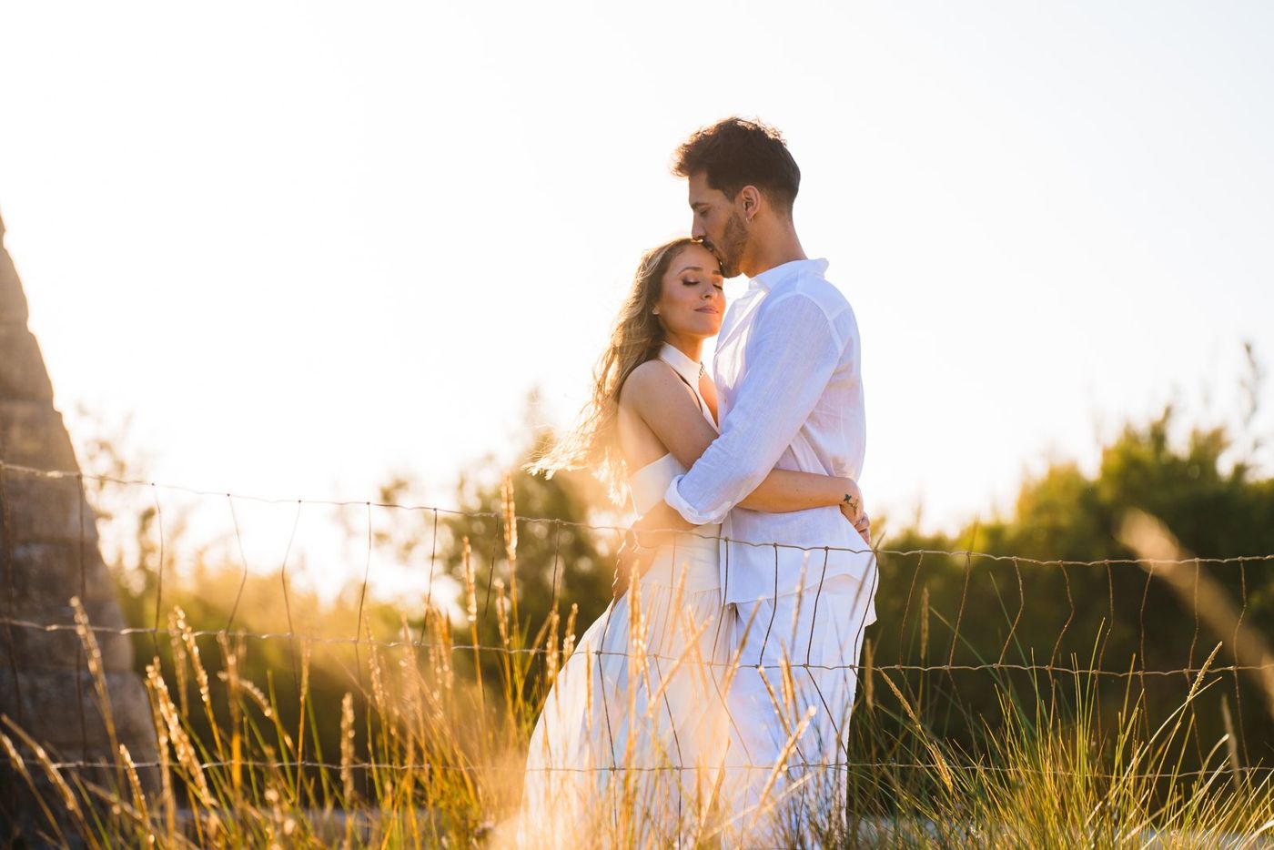 Couple embracing in golden backlight
