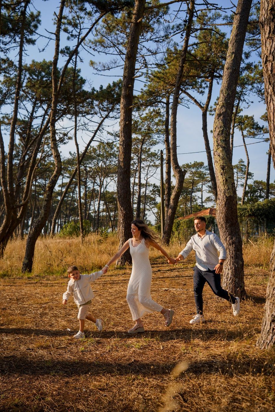 Family running in a pine wood