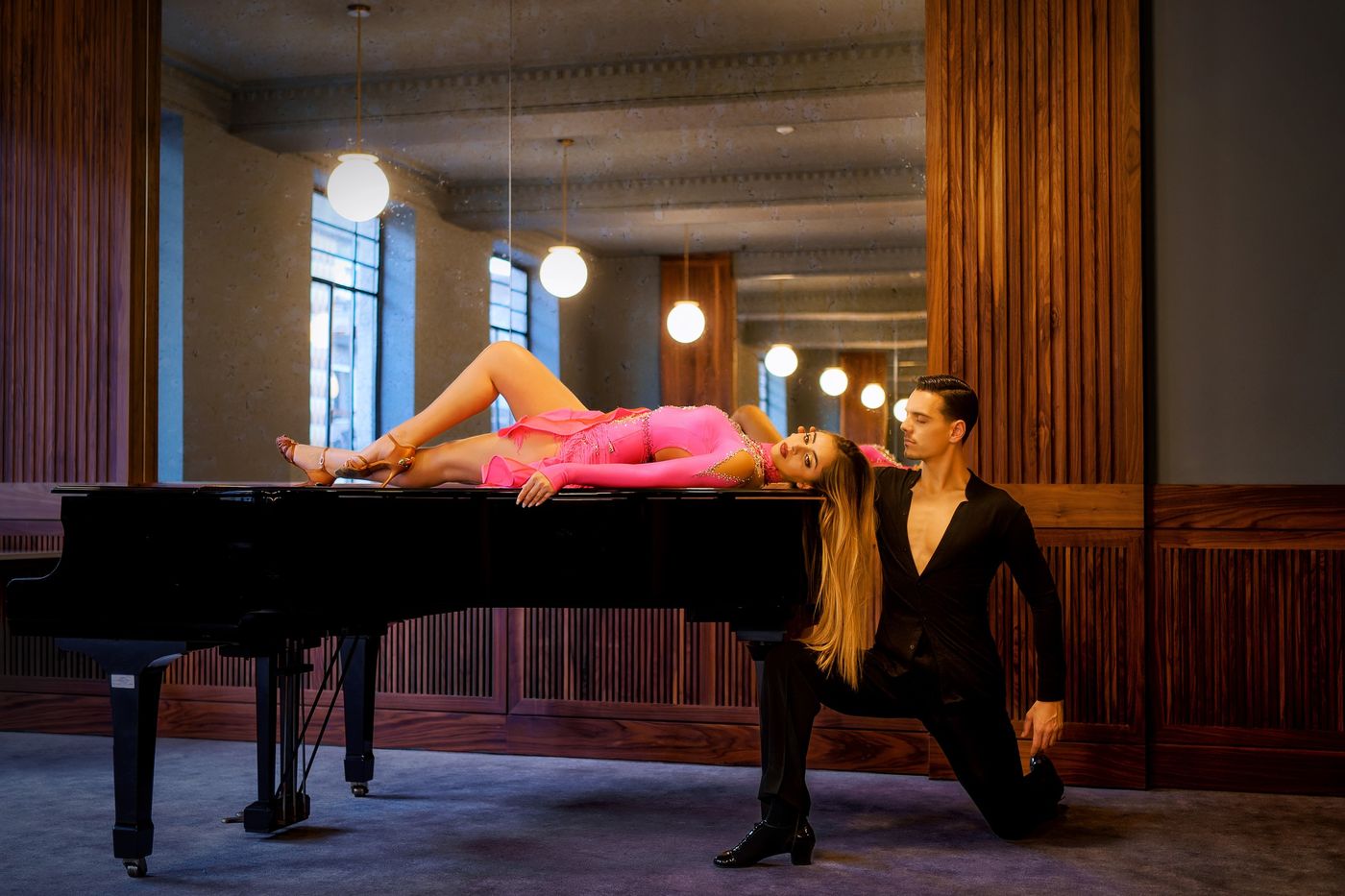Dancers by a grand piano