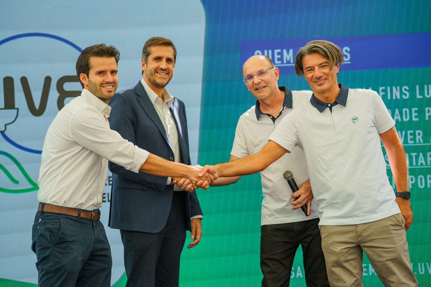 Partners shaking hands on stage