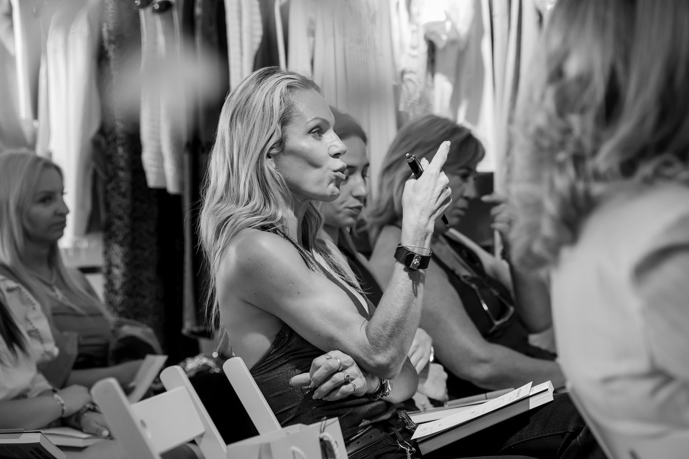 Participant speaking at a workshop, in black and white