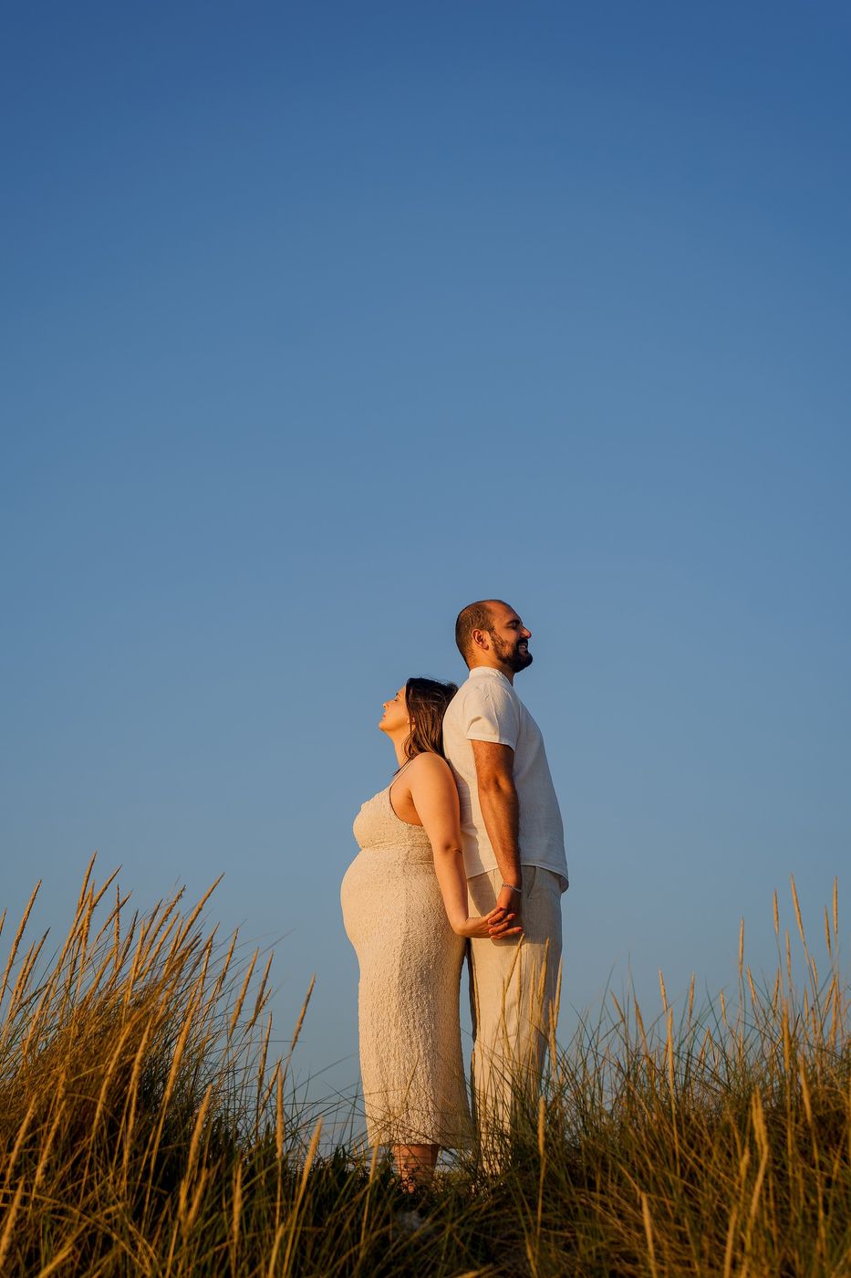 Couple on the dunes under a blue sky
