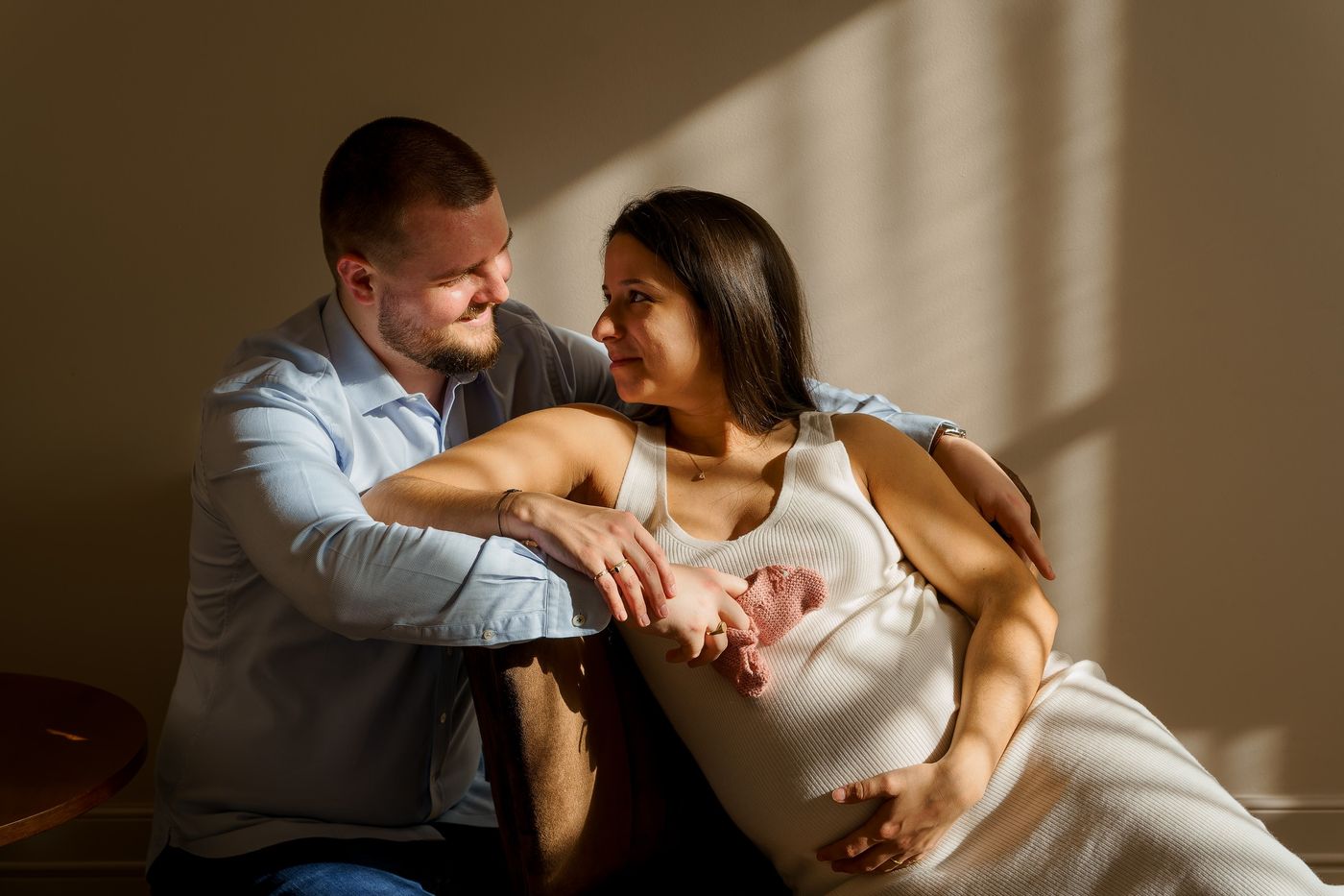 Expecting couple by window light