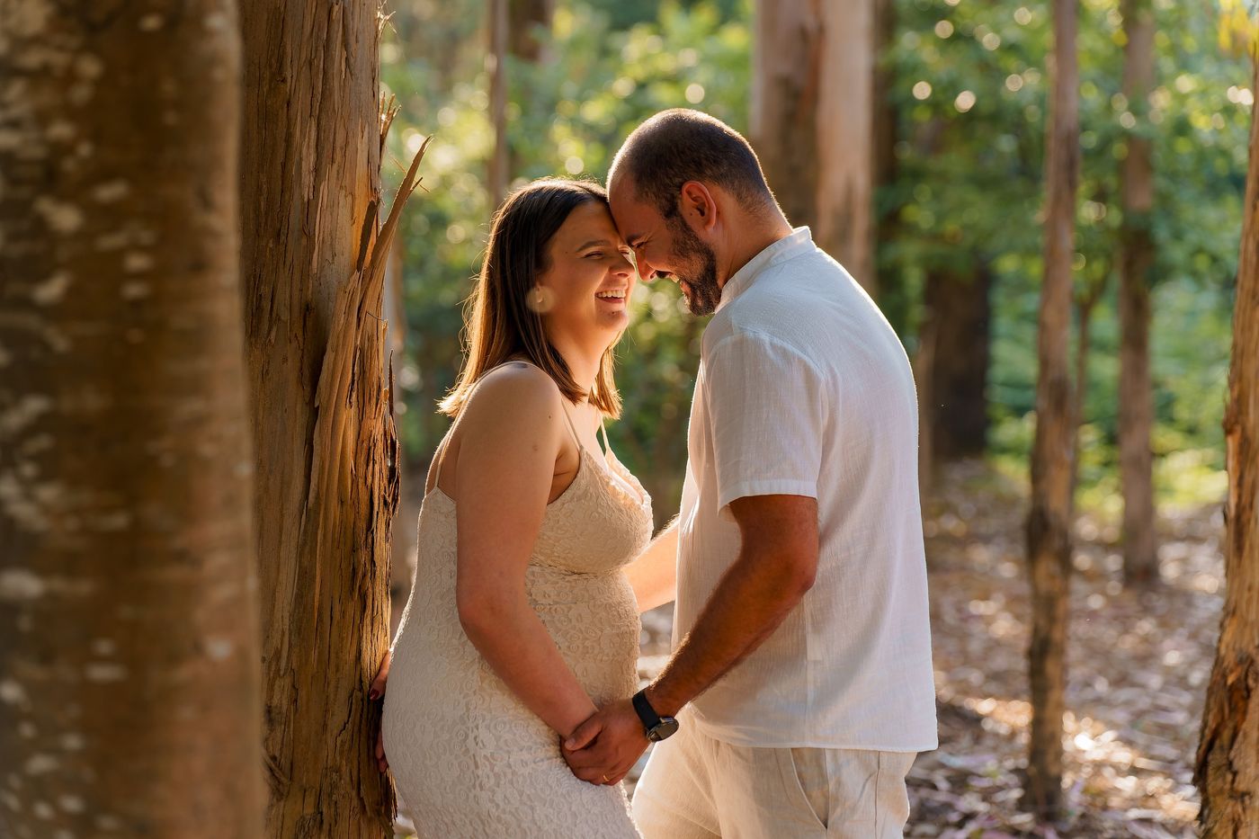 Couple forehead to forehead in a pine wood
